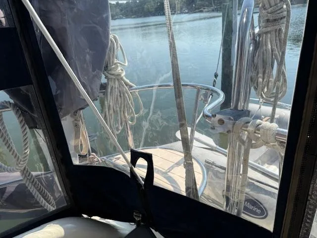 Slide: The Image of 2003 Caliber 40 LRC SE sailboat deck view with ropes and railing, on calm water. - 20