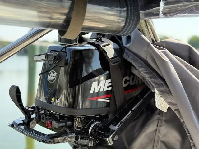 Slide: The Image of Mercury outboard motor on a 2003 Caliber 40 LRC SE sailboat, partially covered. - 21