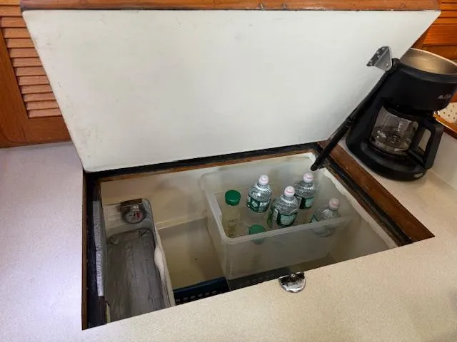 Slide: The Image of Hidden storage compartment on 2003 Caliber 40 LRC SE with water bottles and coffee maker. - 25