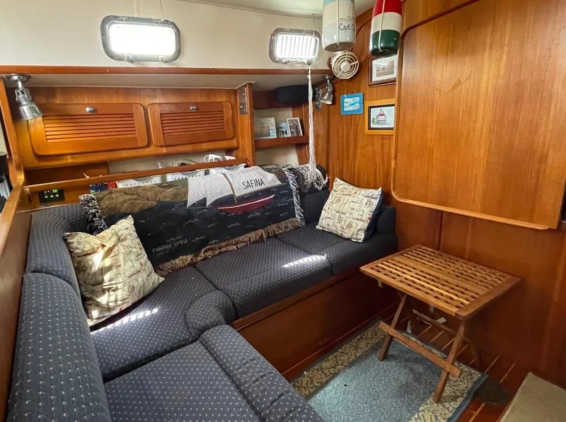 Slide: The Image of Cozy interior of 2003 Caliber 40 LRC SE sailboat with wooden furnishings and cushioned seating. - 28