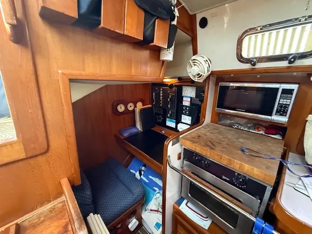 Slide: The Image of 2003 Caliber 40 LRC SE yacht interior with navigation station and galley area. - 31