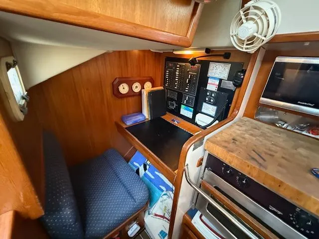 Slide: The Image of Cozy cabin interior of 2003 Caliber 40 LRC SE with navigation station and control panel. - 32