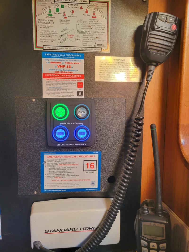 Slide: The Image of Control panel with emergency radio procedures on a 2003 Caliber 40 LRC SE boat. - 34