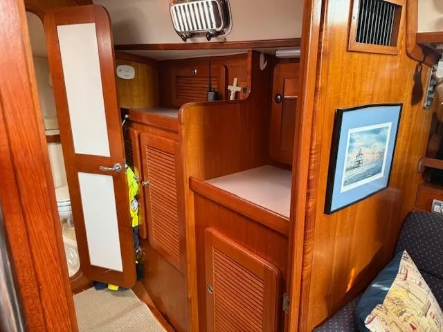 Slide: The Image of Interior of 2003 Caliber 40 LRC SE sailboat with wooden cabinetry and nautical decor. - 35