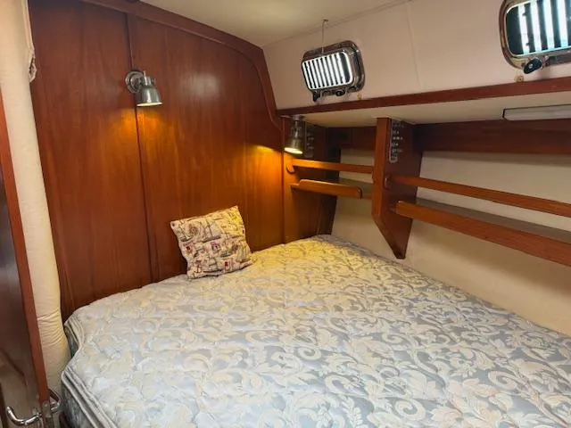 Slide: The Image of Cozy cabin interior of 2003 Caliber 40 LRC SE with wooden accents and bedding. - 36