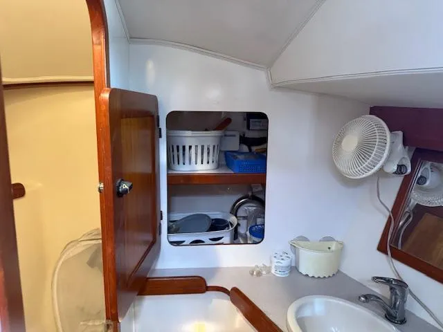 Slide: The Image of 2003 Caliber 40 LRC SE yacht bathroom with storage shelves and sink. - 37