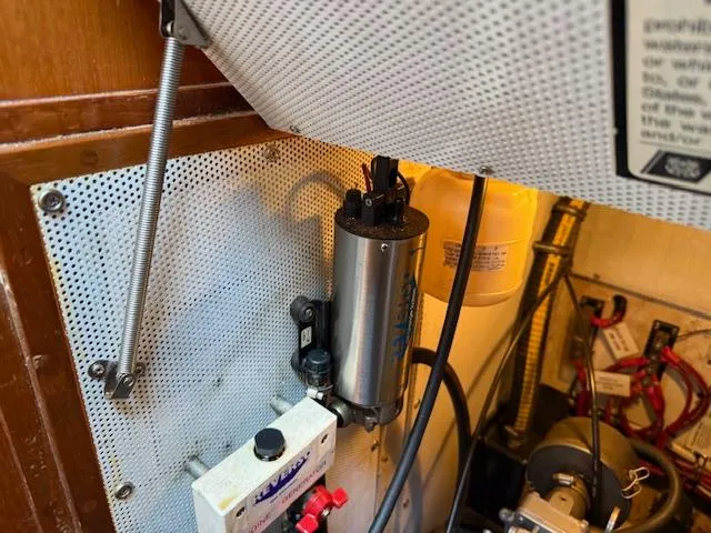 Slide: The Image of Engine compartment of a 2003 Caliber 40 LRC SE sailboat, showing mechanical components and wiring. - 43