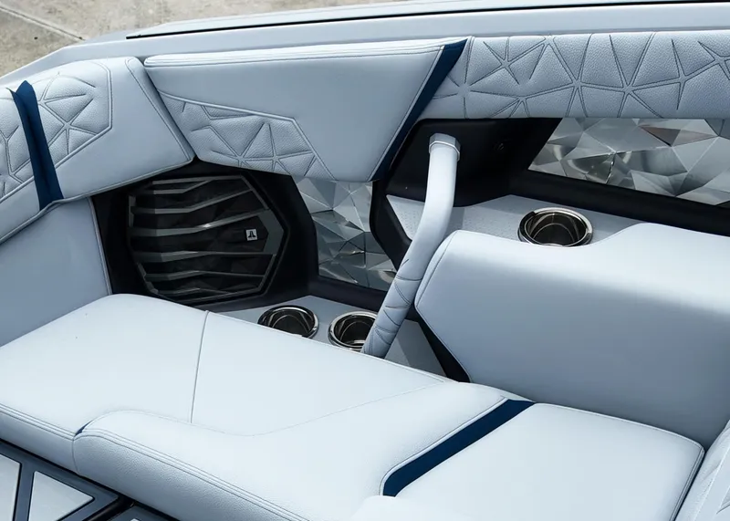 Slide: The Image of 2025 Nautique G23 Paragon interior with luxurious seating and modern speaker design. - 10