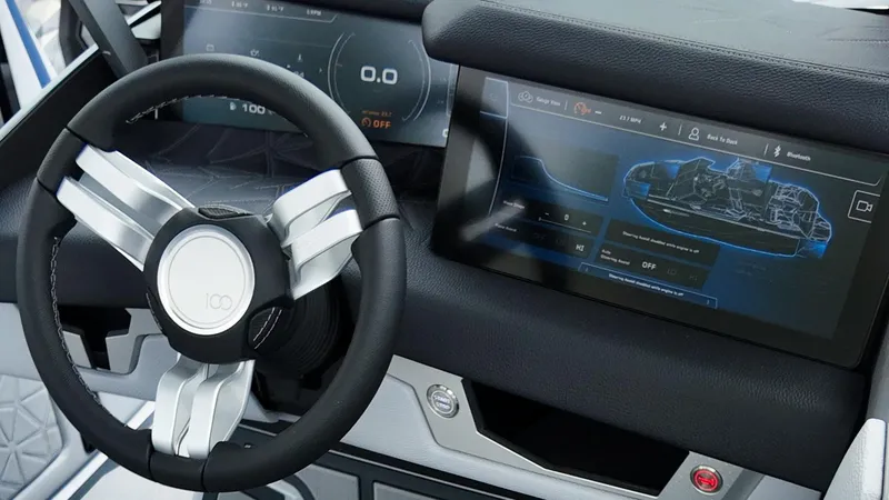 Slide: The Image of 2025 Nautique G23 Paragon dashboard with advanced touchscreen and sleek steering wheel design. - 11