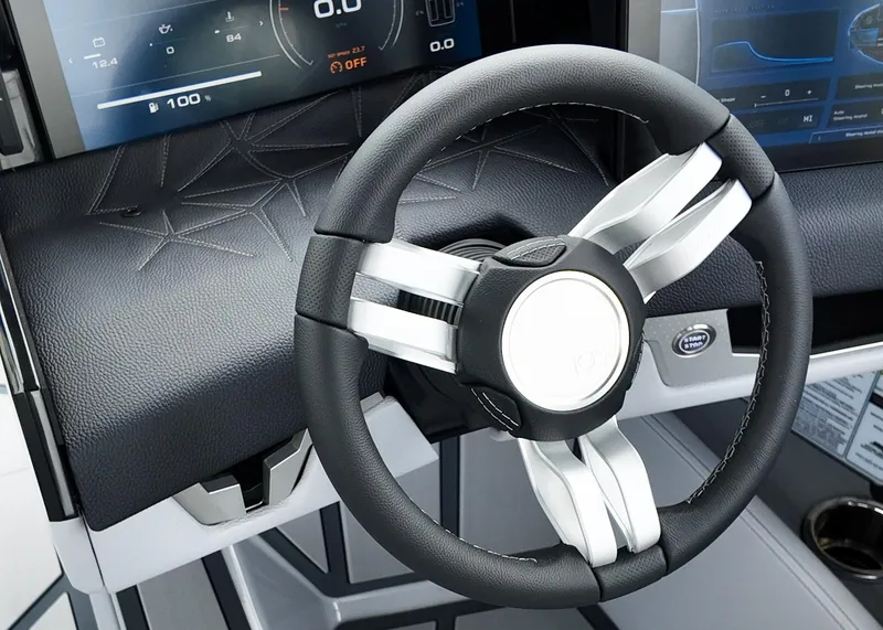 Slide: The Image of Steering wheel of 2025 Nautique G23 Paragon boat with modern dashboard display. - 12