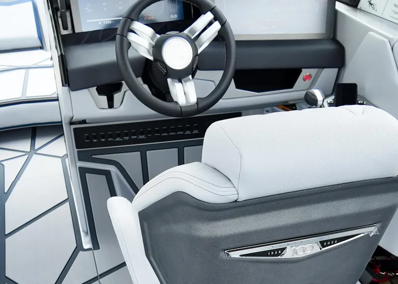 Slide: The Image of 2025 Nautique G23 Paragon boat interior with modern steering wheel and luxurious seating. - 13