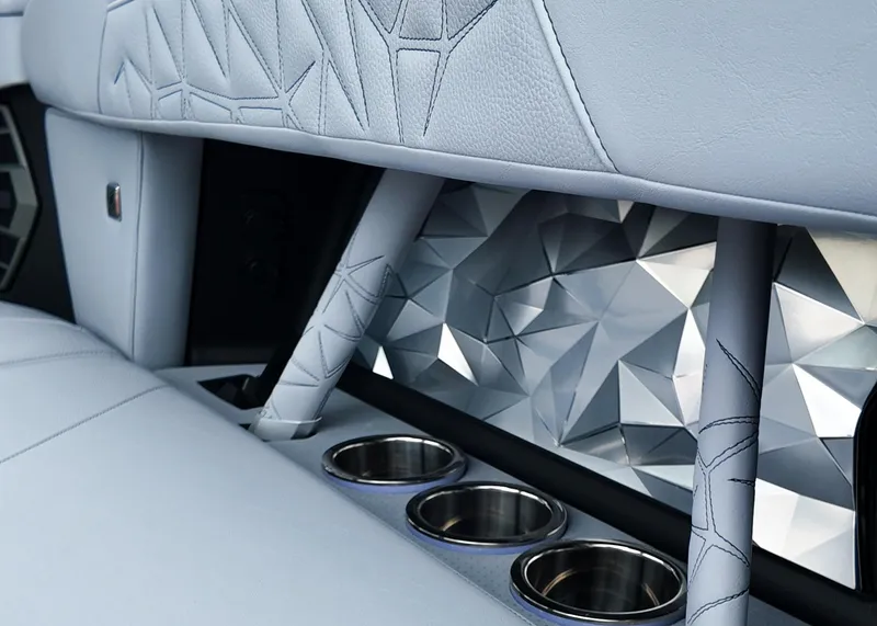 Slide: The Image of 2025 Nautique G23 Paragon interior with geometric design and cup holders. - 14