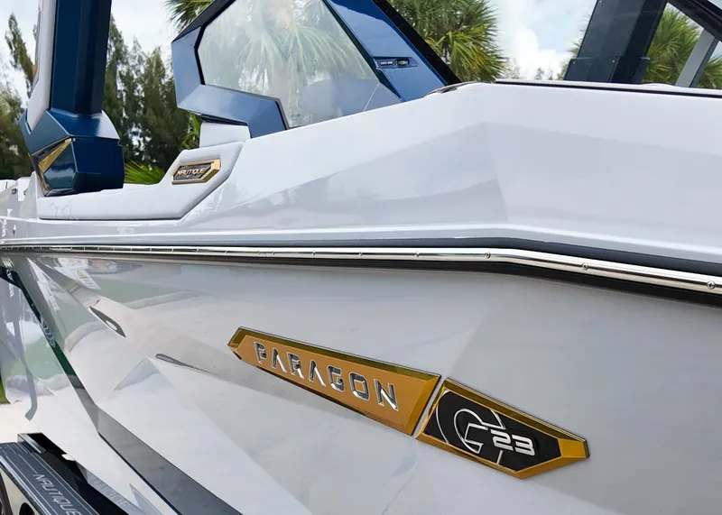 Slide: The Image of 2025 Nautique G23 Paragon boat with sleek design and gold accents. - 19