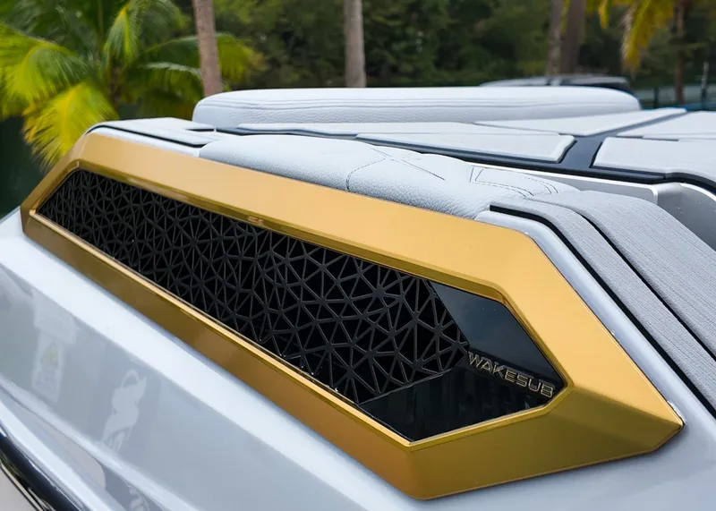 Slide: The Image of 2025 Nautique G23 Paragon boat detail with gold trim and textured design. - 23