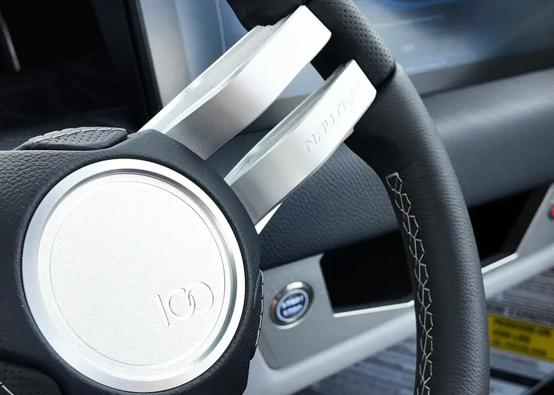 Slide: The Image of 2025 Nautique G23 Paragon steering wheel with sleek design and detailed stitching. - 7