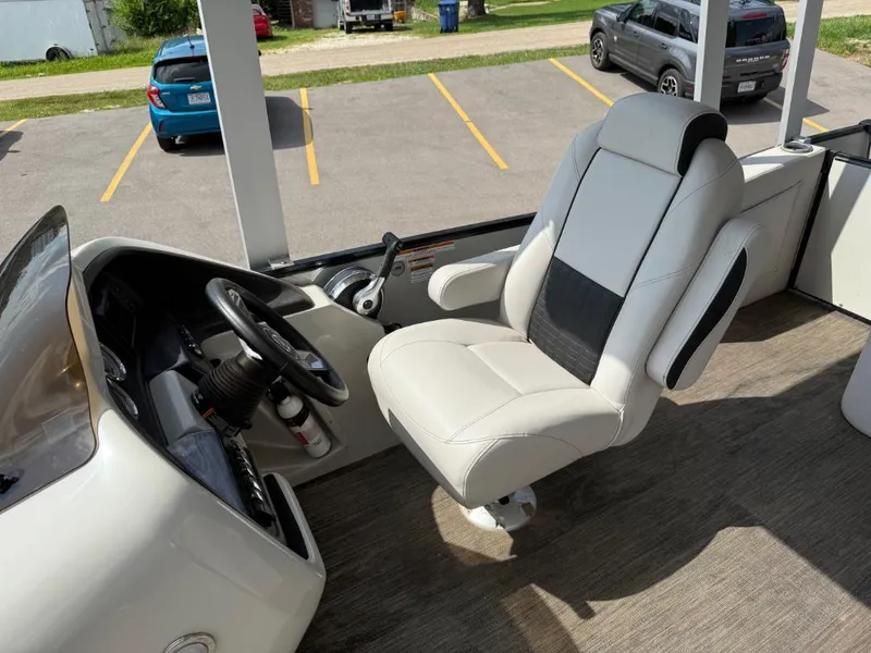 Slide: The Image of Captain's chair and helm of 2022 Avalon 2585 CR boat in a parking lot. - 7