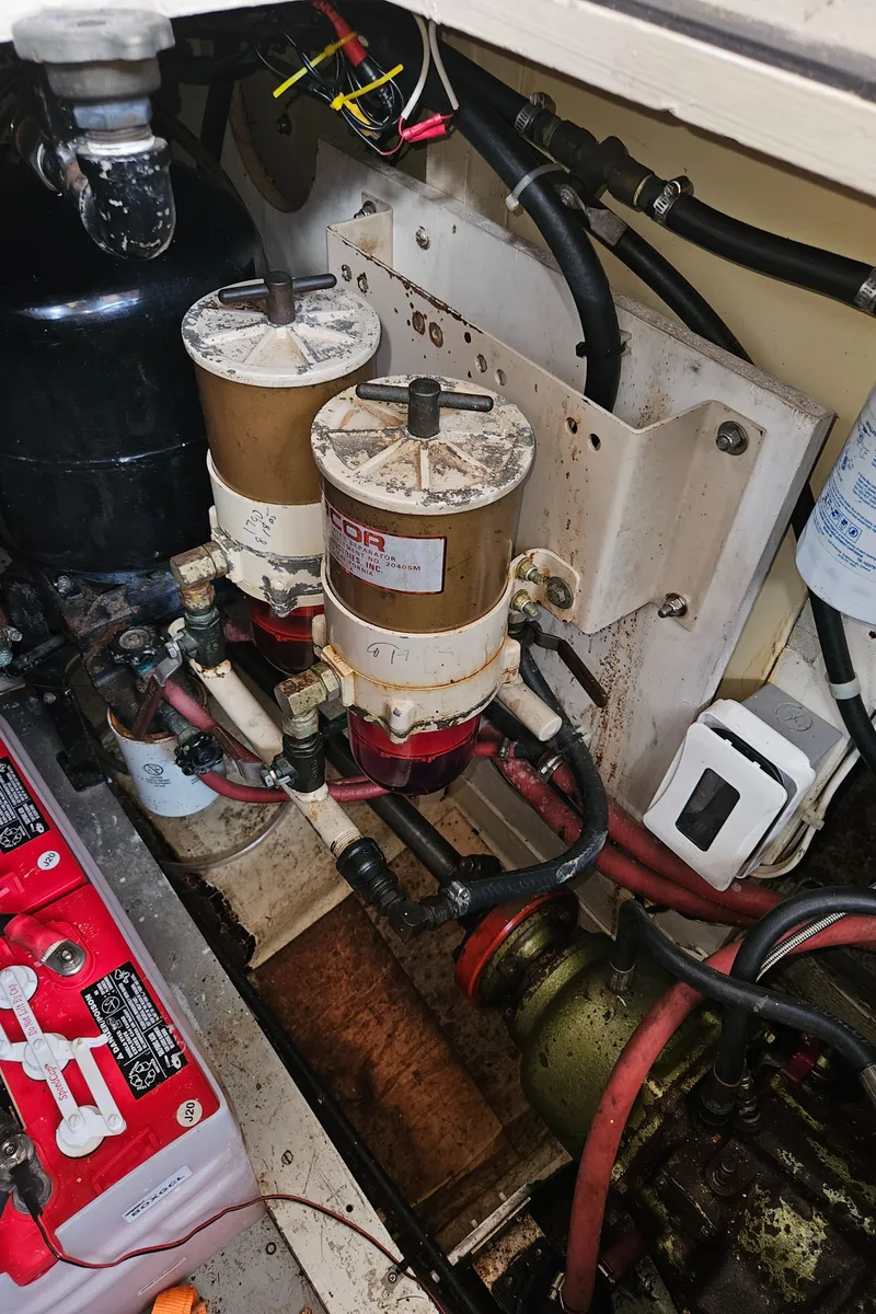 Slide: The Image of Engine room of a 1973 Grand Banks 36 Classic with fuel filters and battery. - 29