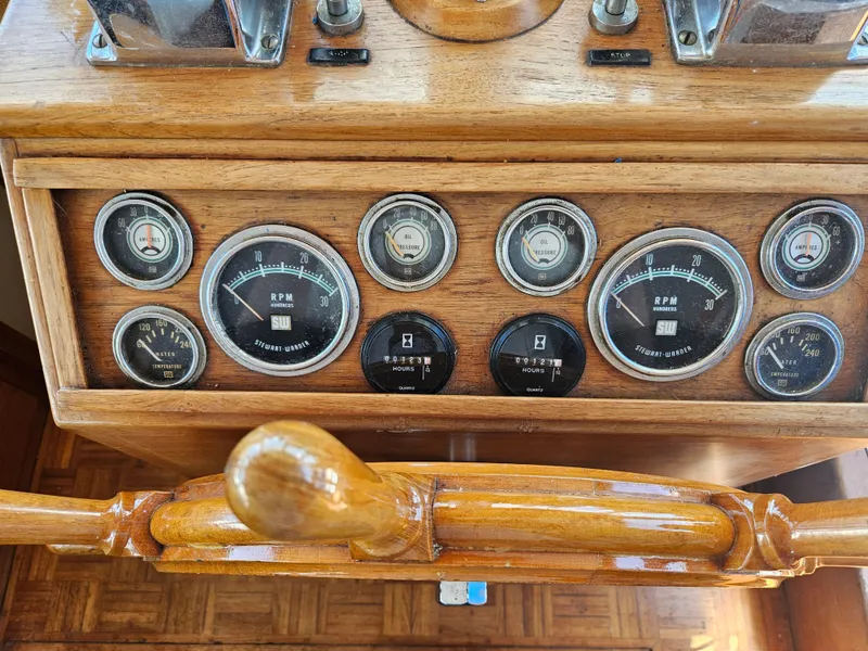 Slide: The Image of 1973 Grand Banks 36 Classic dashboard with vintage gauges and wooden steering wheel. - 3