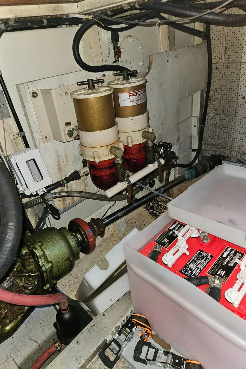 Slide: The Image of Engine room of a 1973 Grand Banks 36 Classic with Racor fuel filters and battery storage. - 30