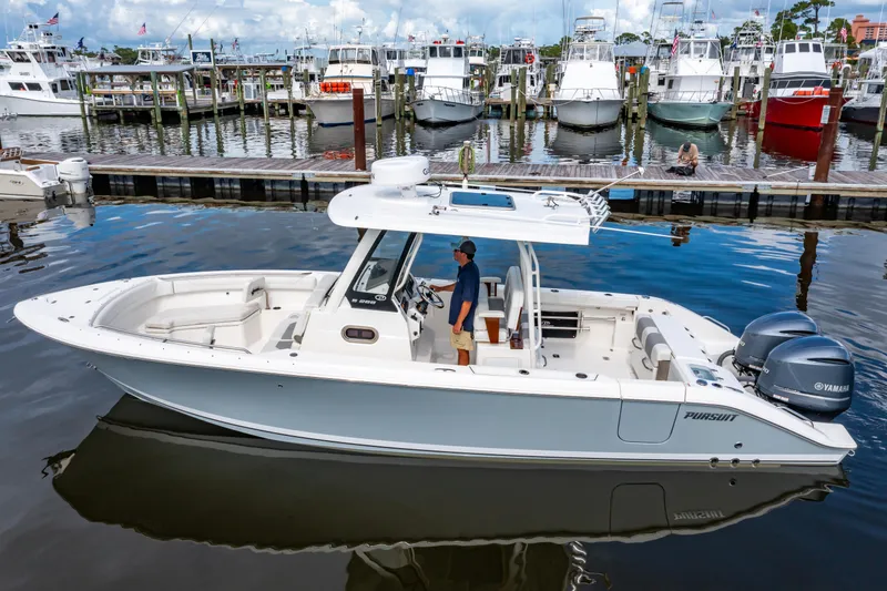 The Image of 2021 Pursuit S 288 Sport boat docked at marina with multiple yachts in background. - 0