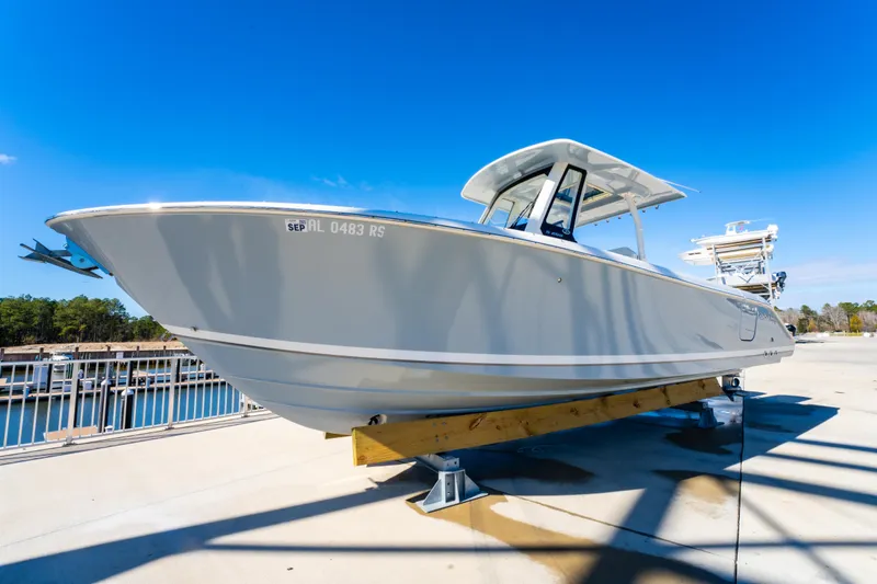 Slide: The Image of 2021 Pursuit S 288 Sport boat on display under clear blue sky. - 13