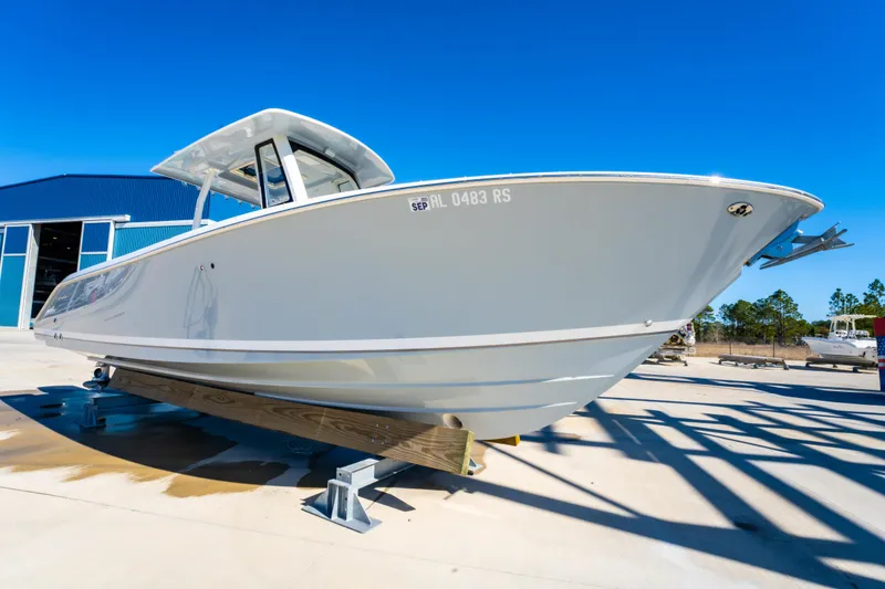 Slide: The Image of 2021 Pursuit S 288 Sport boat on display under clear blue sky. - 14