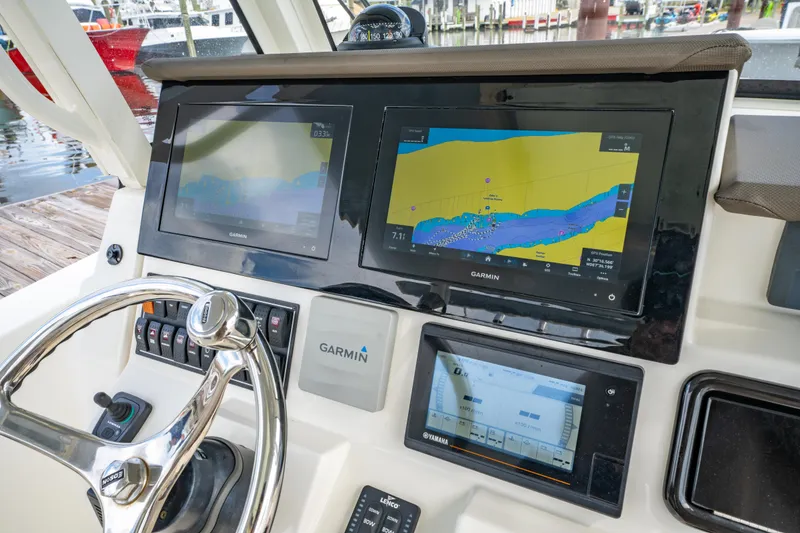 Slide: The Image of 2021 Pursuit S 288 Sport boat dashboard with Garmin navigation displays. - 19