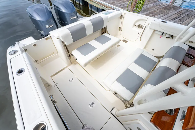 Slide: The Image of 2021 Pursuit S 288 Sport boat interior with seating and twin engines. - 26