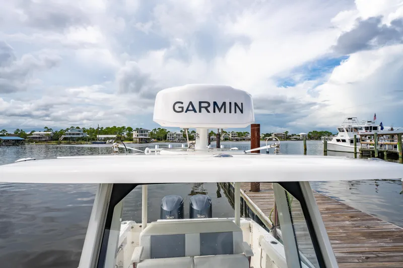 Slide: The Image of 2021 Pursuit S 288 Sport boat with Garmin equipment docked at a marina. - 33