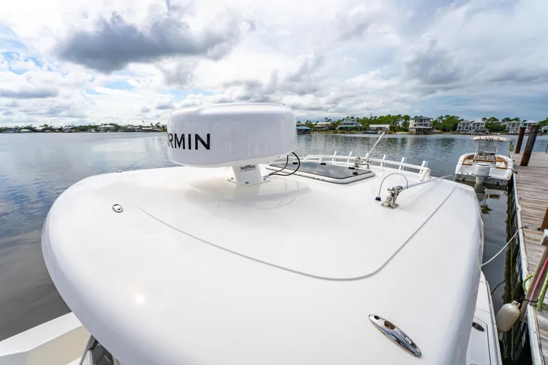Slide: The Image of 2021 Pursuit S 288 Sport boat docked, featuring Garmin radar, under cloudy sky. - 38