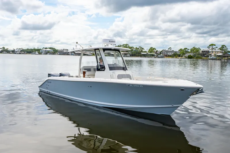 Slide: The Image of 2021 Pursuit S 288 Sport boat on calm water under cloudy sky. - 4