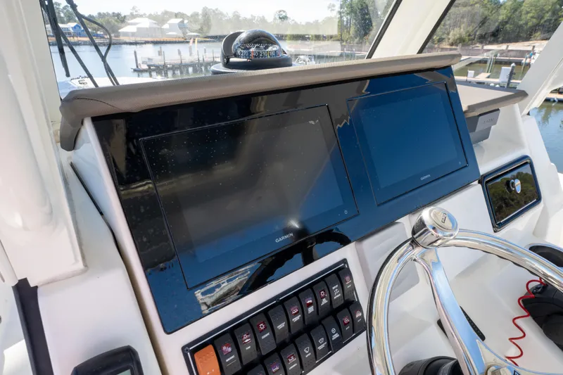 Slide: The Image of 2021 Pursuit S 288 Sport boat dashboard with dual screens and control panel. - 49