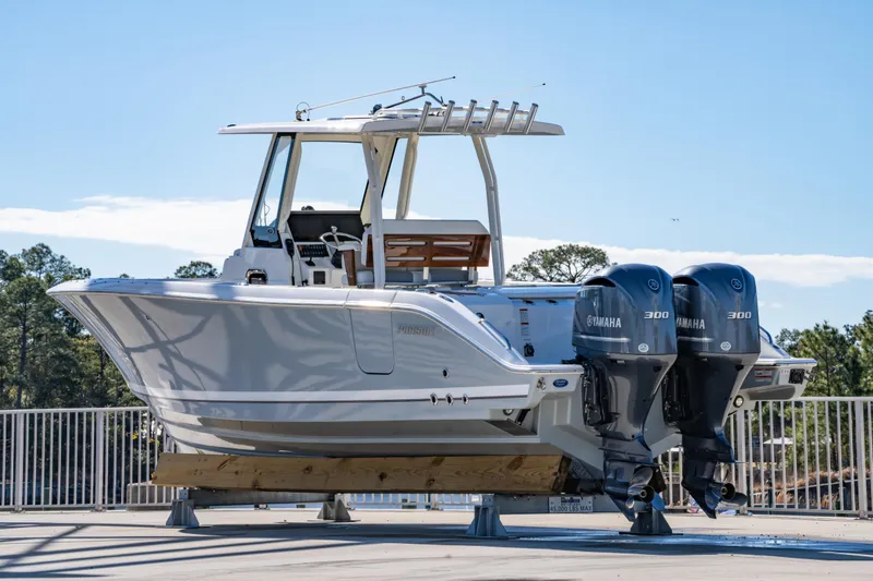 Slide: The Image of 2021 Pursuit S 288 Sport boat with dual Yamaha engines on display outdoors. - 50