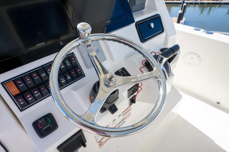 Slide: The Image of Steering console of 2021 Pursuit S 288 Sport boat with controls and display. - 53