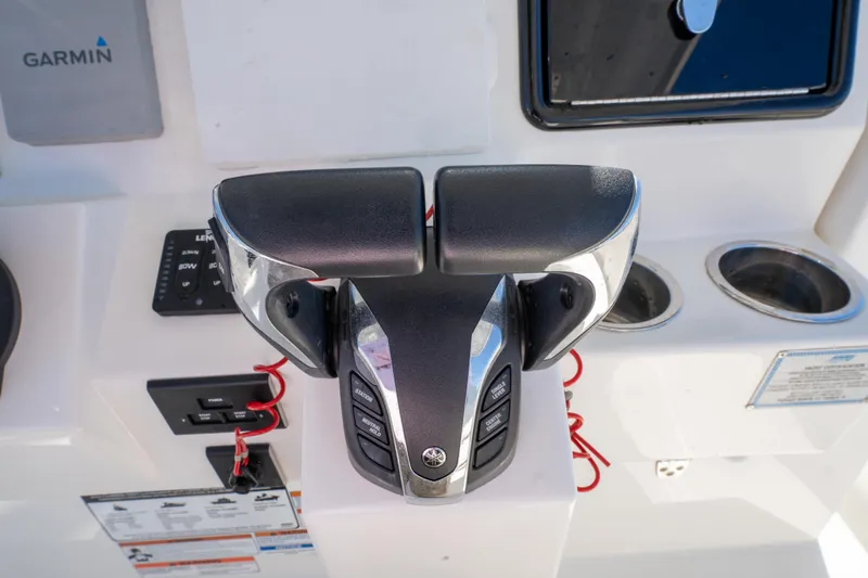 Slide: The Image of Throttle controls on a 2021 Pursuit S 288 Sport boat dashboard. - 54