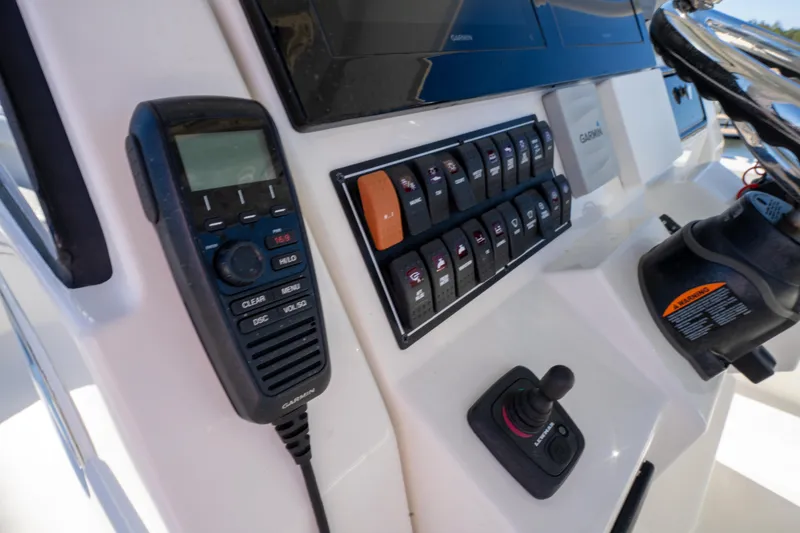 Slide: The Image of Control panel of 2021 Pursuit S 288 Sport boat with radio and switches. - 55