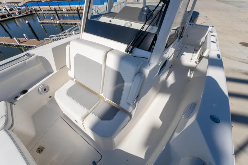 Slide: The Image of 2021 Pursuit S 288 Sport boat interior with cushioned seating and helm station. - 57