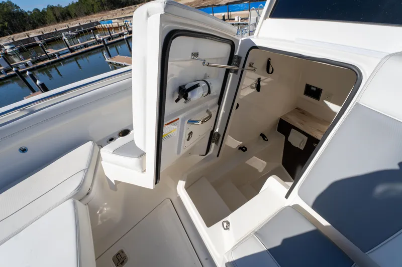 Slide: The Image of 2021 Pursuit S 288 Sport boat interior with open cabin door, dockside view. - 63