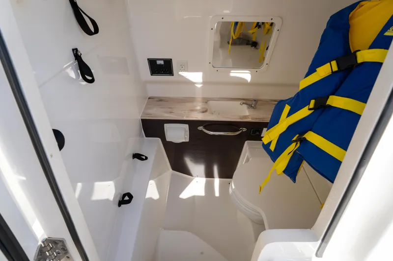 Slide: The Image of Interior of 2021 Pursuit S 288 Sport boat with life jackets and storage area. - 64