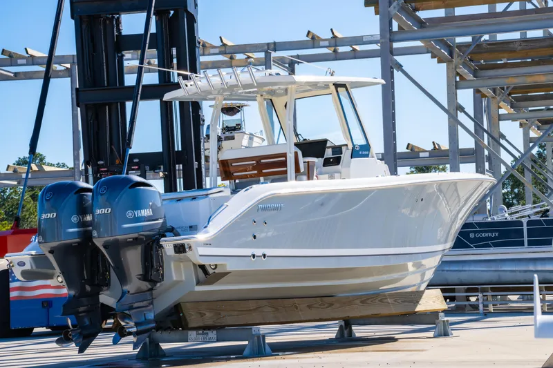 Slide: The Image of 2021 Pursuit S 288 Sport boat with dual Yamaha engines on a dock. - 65