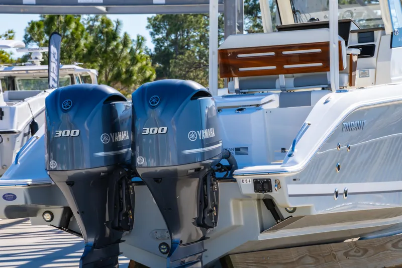 Slide: The Image of 2021 Pursuit S 288 Sport boat with dual Yamaha 300 engines, docked outdoors. - 66