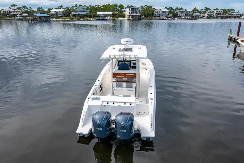 Slide: The Image of 2021 Pursuit S 288 Sport boat with dual engines on a calm lake. - 8