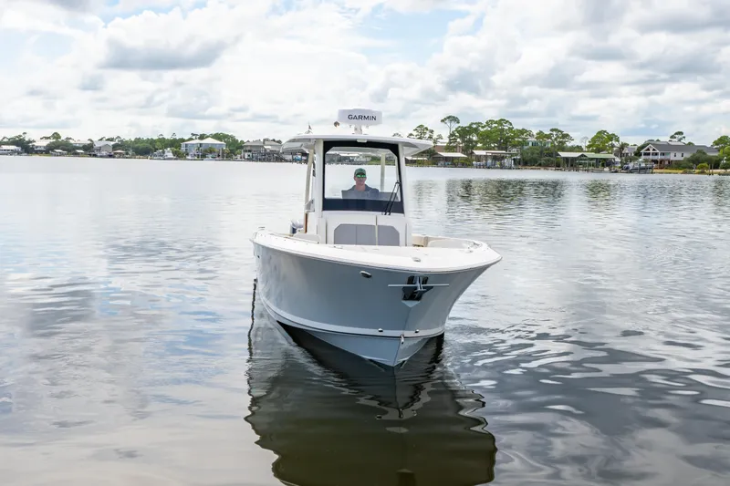 Slide: The Image of 2021 Pursuit S 288 Sport boat on calm water under cloudy sky. - 9
