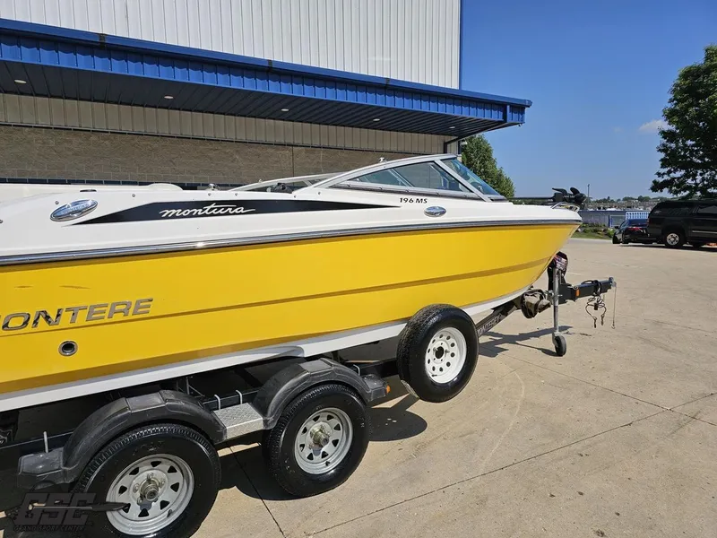 Slide: The Image of Yellow 2015 Monterey 196MFS boat on trailer, parked outdoors near a building. - 12
