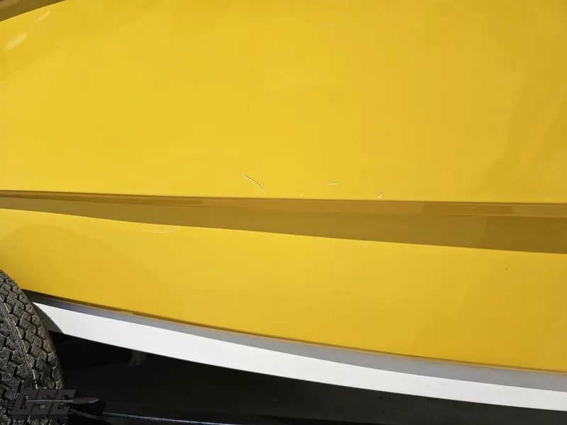 Slide: The Image of Yellow 2015 Monterey 196MFS boat hull with visible scratches and trailer tire. - 16
