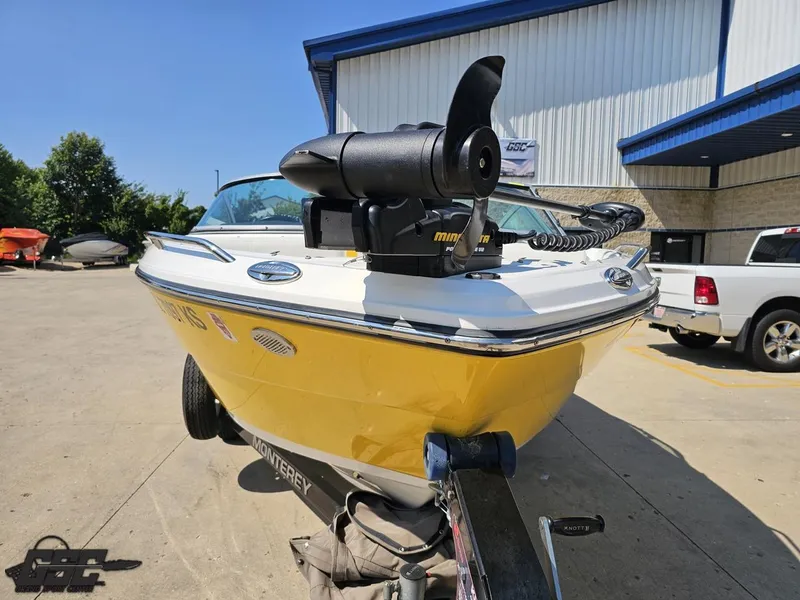 Slide: The Image of Yellow 2015 Monterey 196MFS boat with trolling motor, parked outdoors near a building. - 19