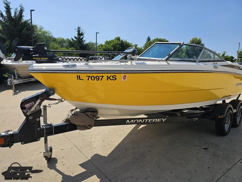 Slide: The Image of Yellow 2015 Monterey 196MFS boat on trailer, parked outdoors on a sunny day. - 23