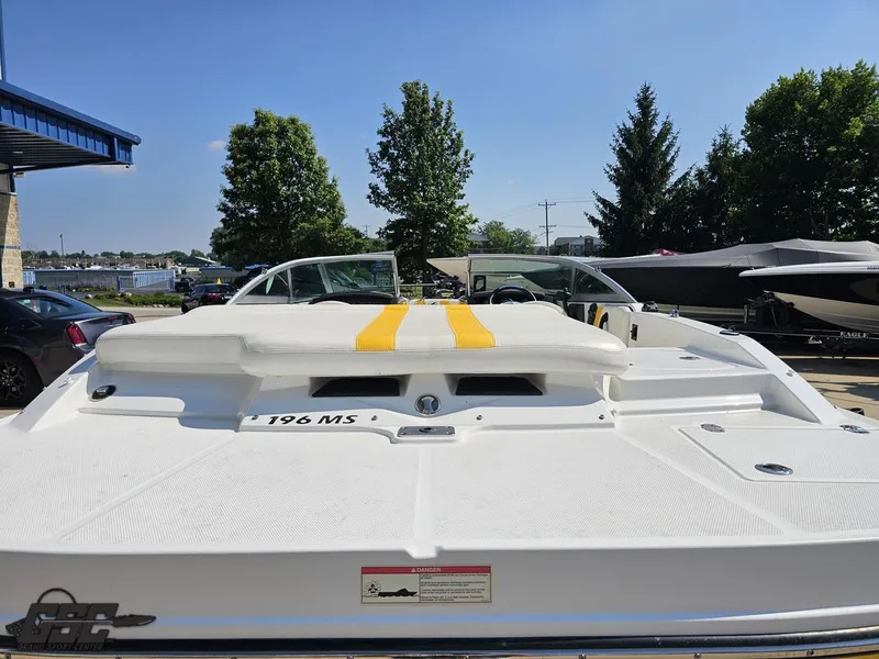 Slide: The Image of 2015 Monterey 196MFS boat with white and yellow seating, parked outdoors. - 40