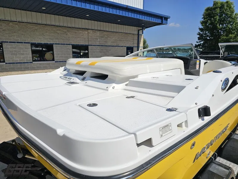 Slide: The Image of 2015 Monterey 196MFS boat with yellow accents, parked outside a building. - 42