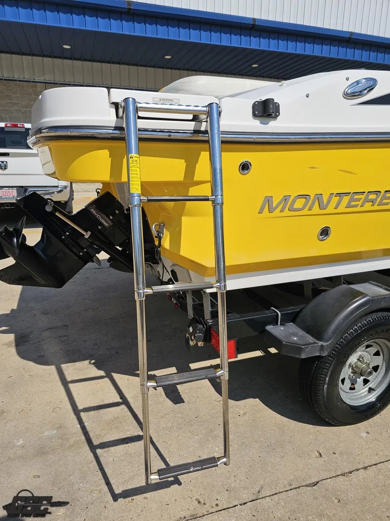 Slide: The Image of Yellow 2015 Monterey 196MFS boat with ladder on trailer, parked outdoors. - 43